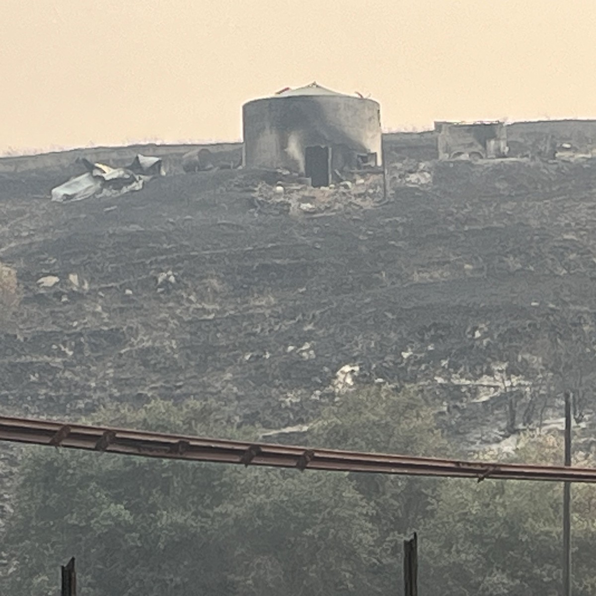 The black hillside after the 2023 fire