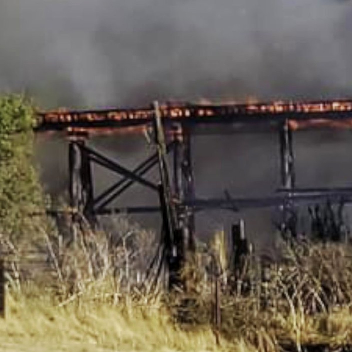 The railroad trestle burning in 2023